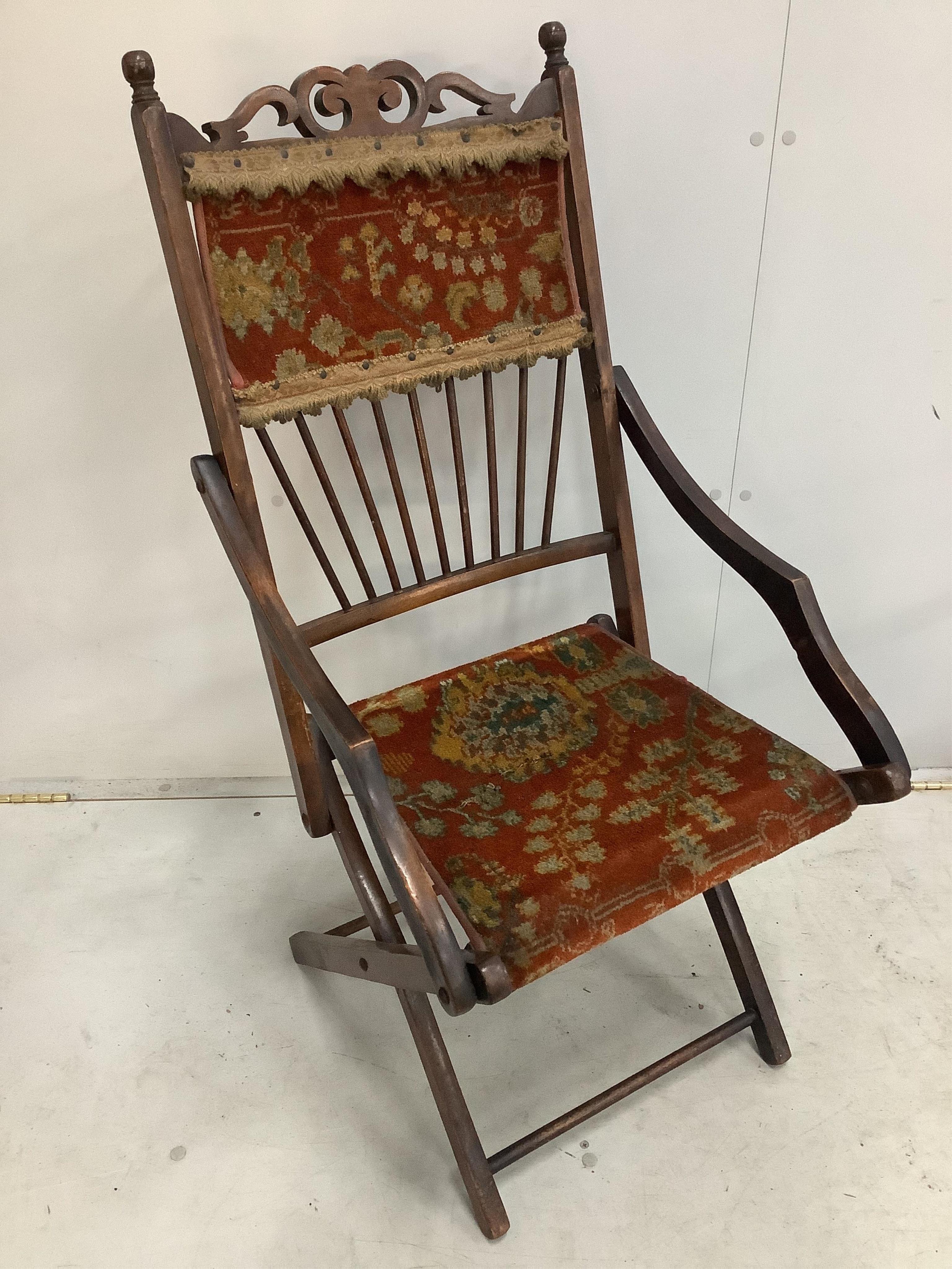 A Victorian folding chair with carpet upholstery and a Regency mahogany elbow chair. Condition - poor to fair